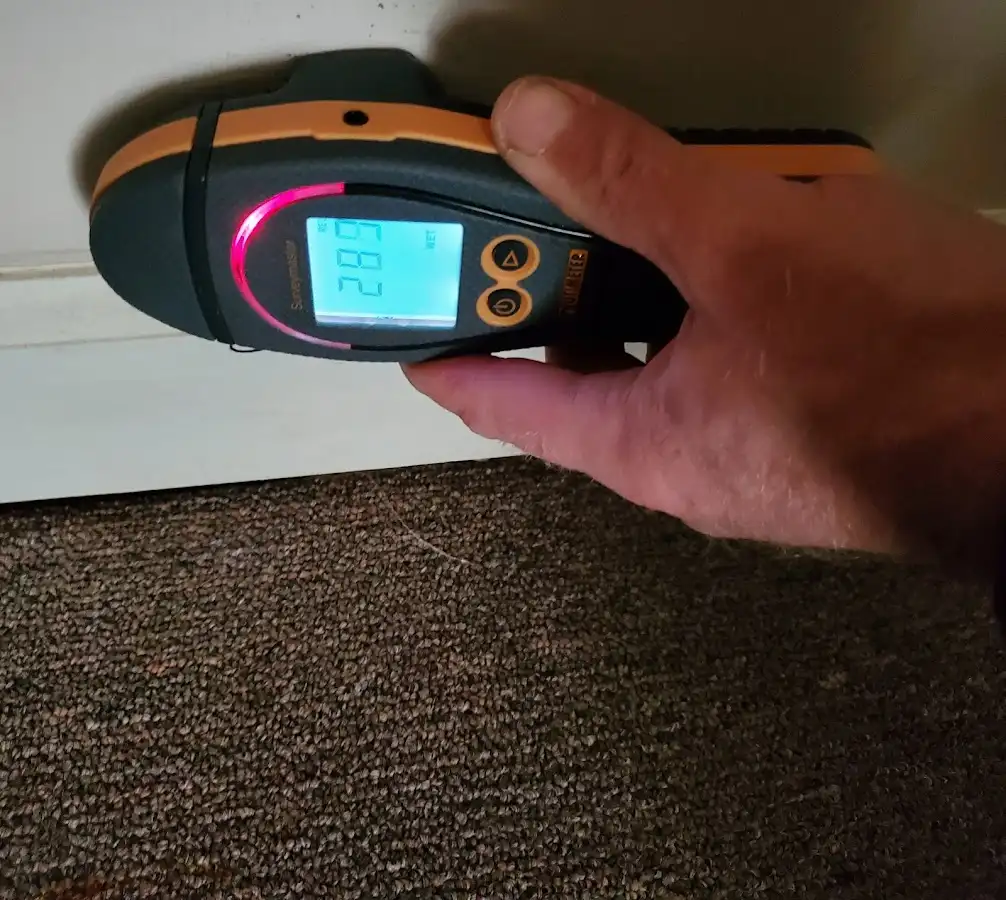 Moisture detection at baseboard during Storm Damage Restoration in Dryden
